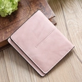 Pink minimalist faux leather bi-fold short wallet for women on a wooden background - Light Pink
