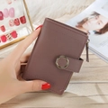 Close-up of lilac pebbled leather wallet with gold ring buckle and side metal zipper - Dusty Pink