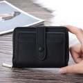 Classic black short PU leather wallet with zipper closure and front card slot held in hand - Black