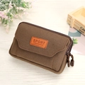 Brown canvas multi-functional waist bag with double zippers and sport label on wood desk - Coffee