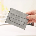 Slim grey matte leather card holder with Elegant Style print held in hand - Light Gray