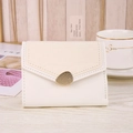 Detail of snake pattern heart wallet featuring gold pebble buckle and creamy leather texture - Milky White