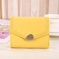 Detail of yellow heart card holder with faux crocodile texture and pebble metal buckle - Yellow