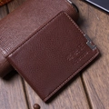 Brown litchi grain leather driving license holder with metal accent on wood desk - Light Coffee