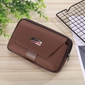 Brown canvas phone waist bag with SPORT logo on light wooden background with greenery - Horizontal Coffee (17.5cm/6.5in)