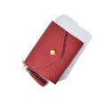 Detail of red quilted faux leather wallet with triangle pendant and fringe tassel - Red