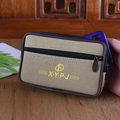 Khaki canvas waist bag with dual zippers showing a phone being placed inside - Horizontal Beige 17cm