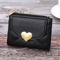 Short black faux leather wallet with heart metal buckle on rustic wooden background - Black