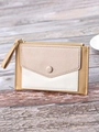 Close-up of tricolor leather card holder with gold zipper on a rustic wooden desk - Tan