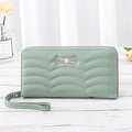 Long mint green women's wallet with wave quilting and golden bow charm on wood surface - 7" / Light Green