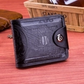 Macro detail of bifold wallet with 100 dollar bill emboss and secure snap closure - Black