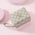 Close-up of beige letter print trifold wallet with round gold metal M logo detail - Beige