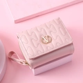 Pink quilted short wallet for women featuring a gold V-logo and wave stitch design - Pink