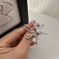 Polished S925 sterling silver bow knot earrings held by hand to show size and scale - 925 Silver / Silver (EHL020)