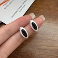 Hand holding S925 sterling silver oval stud earrings with black onyx in matte finish - Silver Brushed Black Agate Style (JZF058)