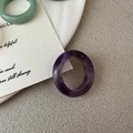 Detail view of natural amethyst and green jade rings with smooth polished finish - Amethyst