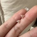 Close-up of minimalist S925 sterling silver triangle stud earrings held by fingers - 925 Silver / Triangle