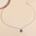 Elegant silver heart necklace with mother and child silhouette on beige background - Silver