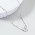 Minimalist silver stainless steel crown necklace with hollow pendant on white display - Steel
