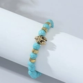 Blue weathered agate bead bracelet featuring a golden Spartan helmet and textured metal charms - Turquoise
