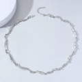 Minimalist silver punk thorn necklace with adjustable lobster clasp on grey surface - Necklace