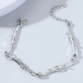 Detail showing the adjustable lobster clasp and thorn-style metal chain design - Bracelet