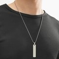 Close-up of minimalist silver stainless steel bar pendant on a ball chain for men - Silver