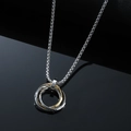 Macro shot of interlocked gold and silver rings with a small diamond on a box chain - Gold Necklace