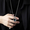 Close-up of men's square geometric pendant necklace with silver and blue metal details - Blue