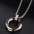 Macro shot of interlocking triple ring pendant necklace with crystal accents and box chain - Rose Gold Triple Ring