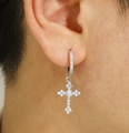 Silver cross earrings with white zircon inlays worn by model in a close-up shot - Silver