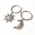 Vintage silver sun and moon pendant set with intricate engraved details on white background - Sun Moon Keychain