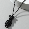 Matte black street style bearbrick pendant necklace on a geometric display stand - Black