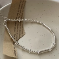 Minimalist S925 sterling silver beaded bracelet with rectangular tube beads on ceramic tray - Minimalist Beaded Style (21SL34) / 925 Silver