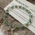 S925 sterling silver beaded bracelet with blue and green crystals on vintage linen - Beaded Style (22SL22) / 925 Silver