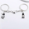Magnetic astronaut couple keychains in silver metal with heart shaped connector - One Pair / Silver