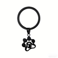 Detail of black cat paw projection stone pendant on a matte metal keychain ring - Black