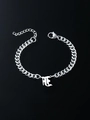 Detailed close-up of a silver cuban link bracelet with a gothic letter pendant on black surface - Letter F