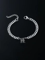 Macro detail of gothic H letter pendant on silver curb chain with lobster clasp - Letter H