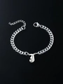 Macro detail of silver stainless steel curb chain bracelet with gothic letter J pendant - Letter J
