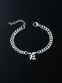 Detailed macro of silver Cuban chain bracelet with Gothic LA pendant and lobster clasp - Letter N