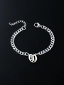 Detail view of silver Cuban link bracelet with engraved oval alphabet letter pendant - Letter O