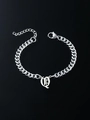 Macro shot of silver Cuban link bracelet featuring a Gothic letter pendant and lobster clasp - Letter Q