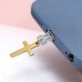 Golden stainless steel cross pendant phone dust plug accessory in a close-up macro view - Gold (For iPhone)