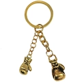 Golden boxing glove pendant keychain with metallic luster and realistic stitch textures - Double Boxing Gloves Gold