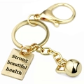 Goldener Box-Kettlebell-Schlüsselanhänger mit graviertem Strong Beautiful Health Anhänger - Gold Eckiges Schild Und Kettlebell Kombi