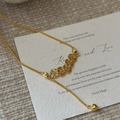 Elegant gold woven necklace featuring micro-coin charms and a polished heart pendant - 925 Silver / Gold (XL341)