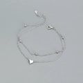 Pulsera de doble capa de plata s925 con un dije de corazón pulido y cuentas redondas - Oro Blanco