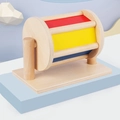 Tamburo rotante Montessori in legno con pannelli colorati su base azzurra - Multicolore