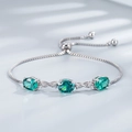 Verstelbare S925 zilveren armband met drie ovale groene smaragden en infinity schakels - 925 zilver / Smaragd